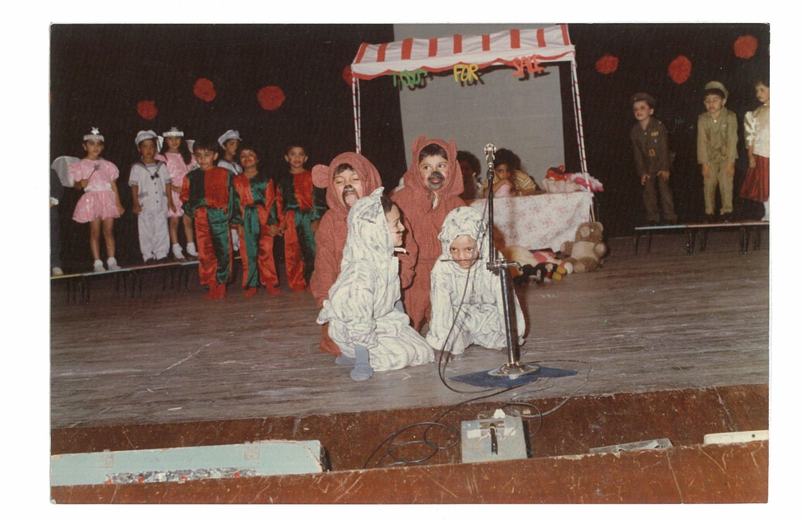 Children in costume on the NAS stage during a school performance