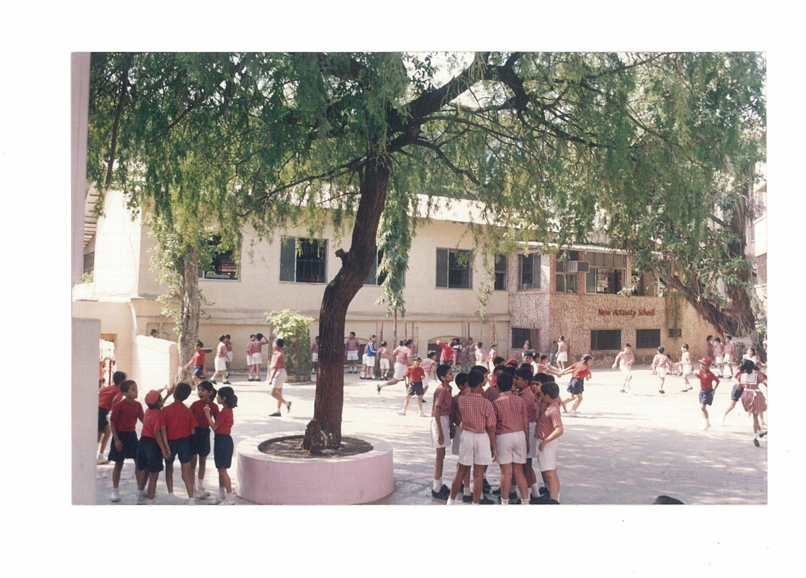 Children playing in the New Activity School courtyard in an older archive photograph