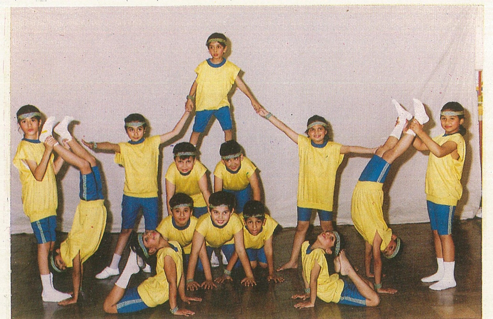 Children in yellow costumes arranged for a performance